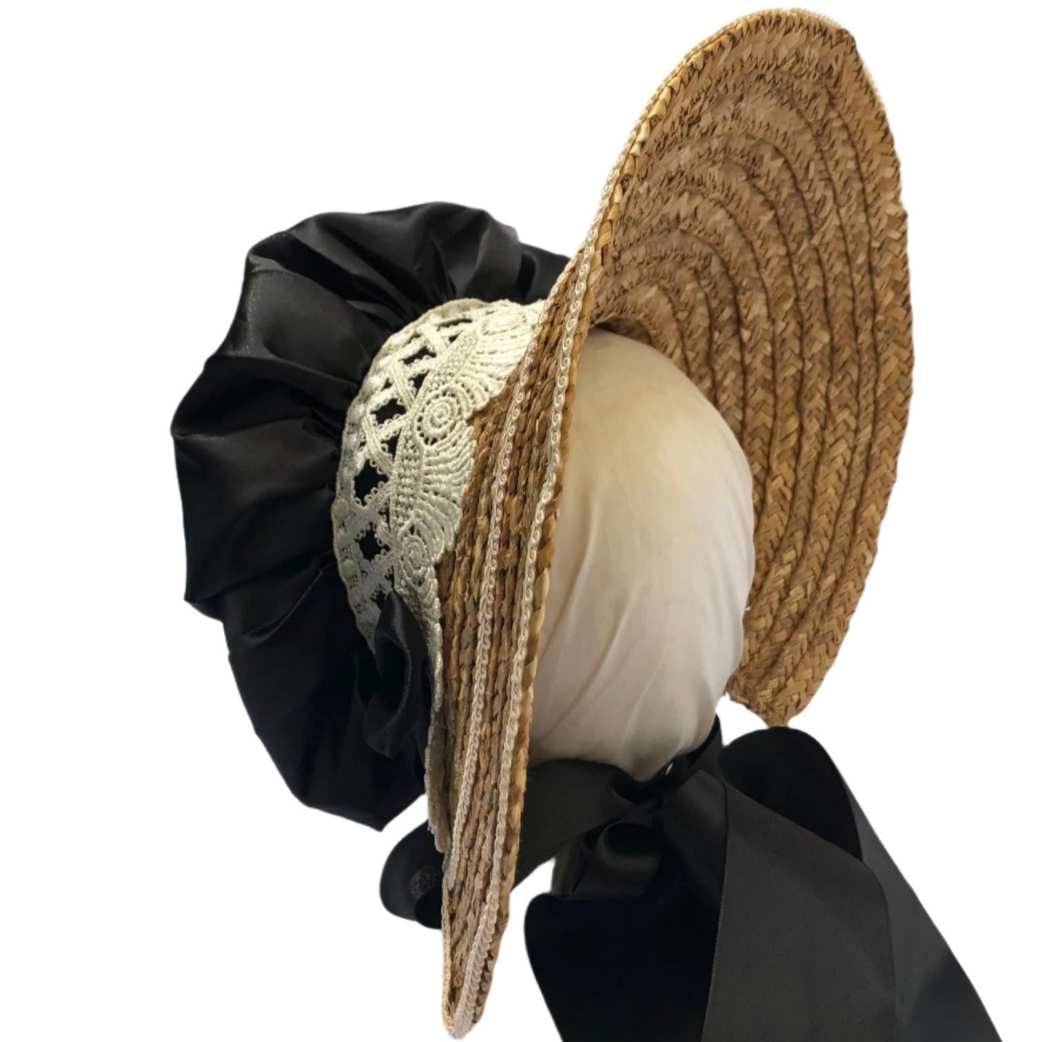 Woven straw hat with a large black bow on a white background