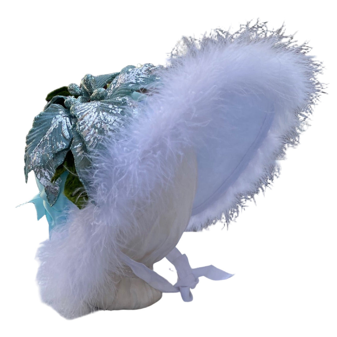 dreamy white winter caroler bonnet with aqua ribbons and feather trim. 