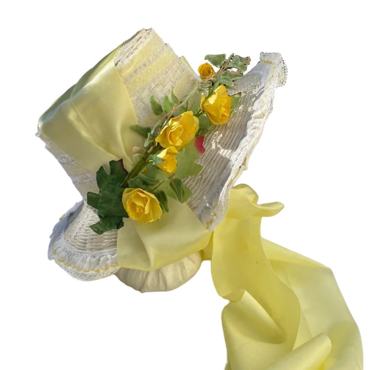 Side view of white wicker Regency bonnet made in "Pamela" style with vintage yellow trim